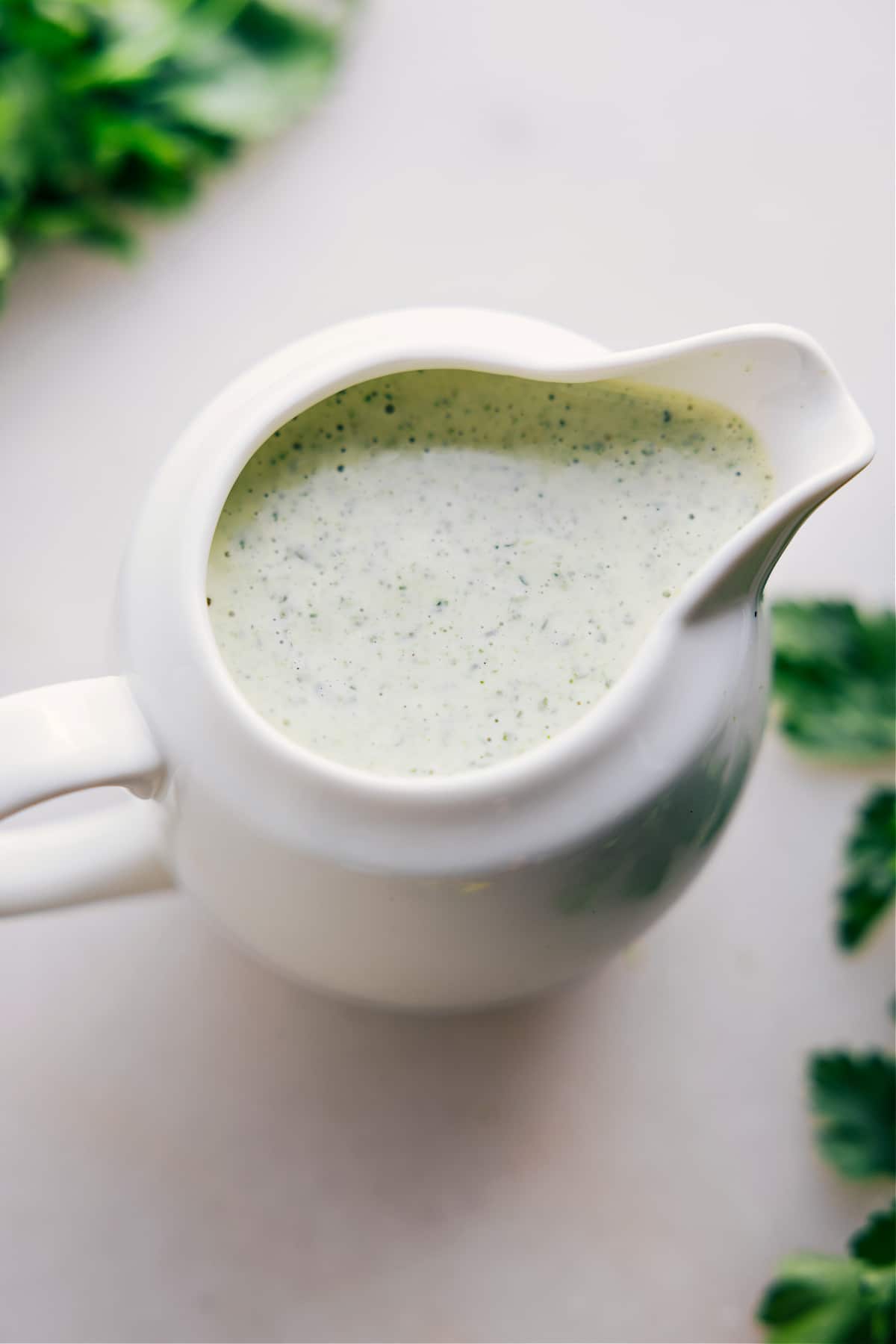 Green Goddess Dressing in a jar, perfect for dipping or drizzling over a salad.