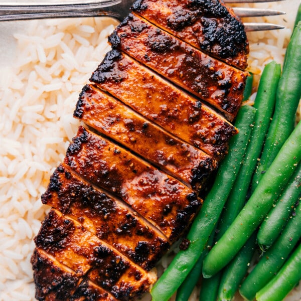 Easy Blackened Chicken recipe over a bed of rice with green beans on the side.