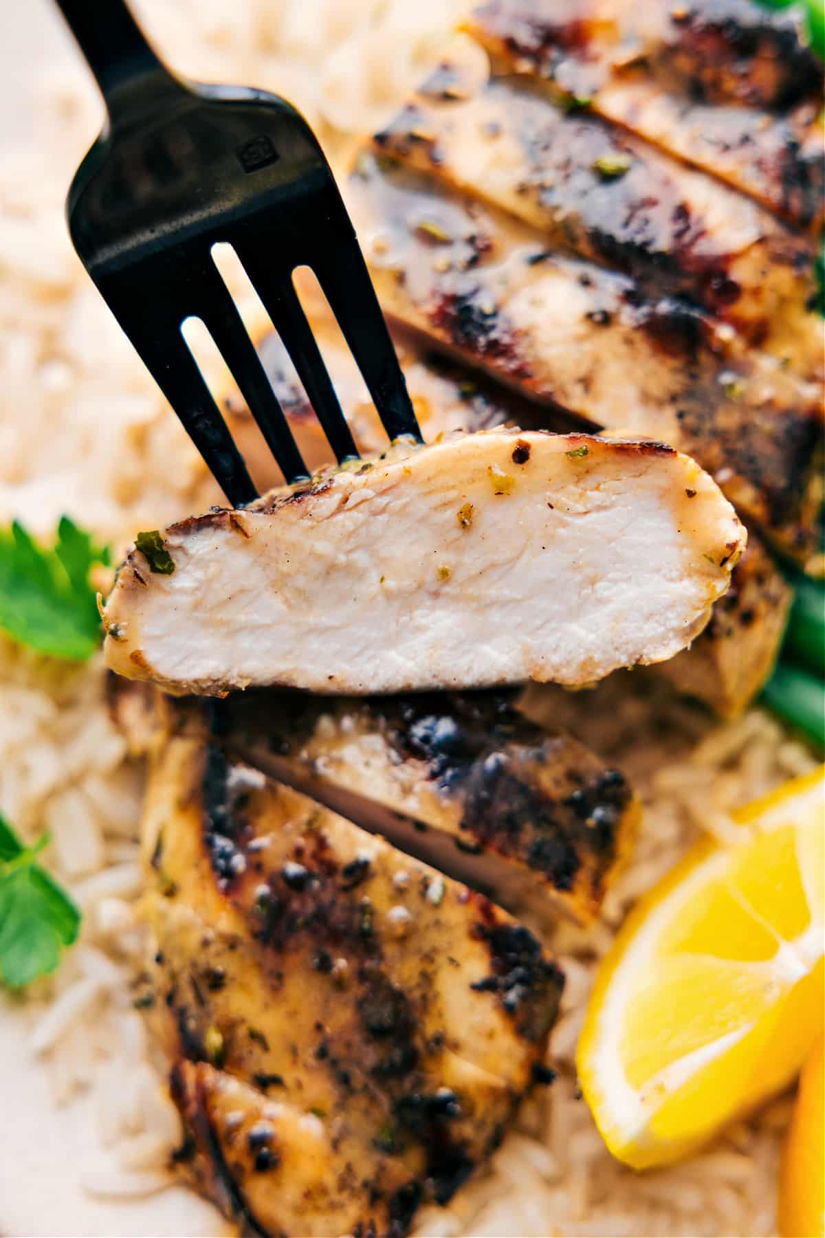 A piece of the meat being picked up with a fork showing how juicy and tender it is.