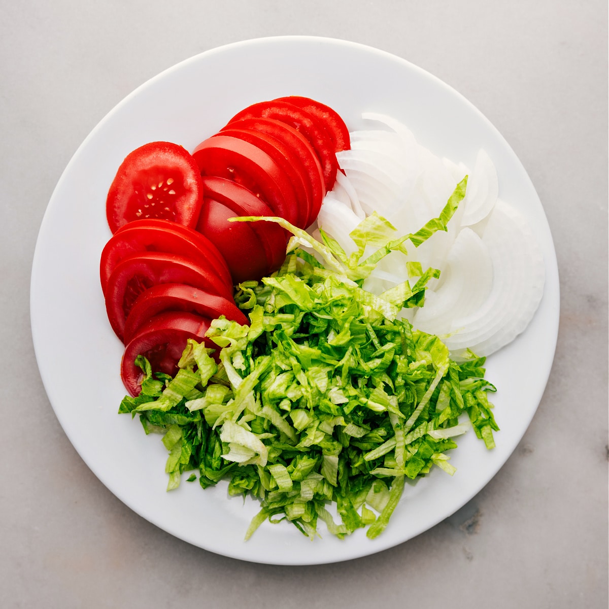 The tomatoes, onions, and lettuce finely chopped for these Italian Hoagies.