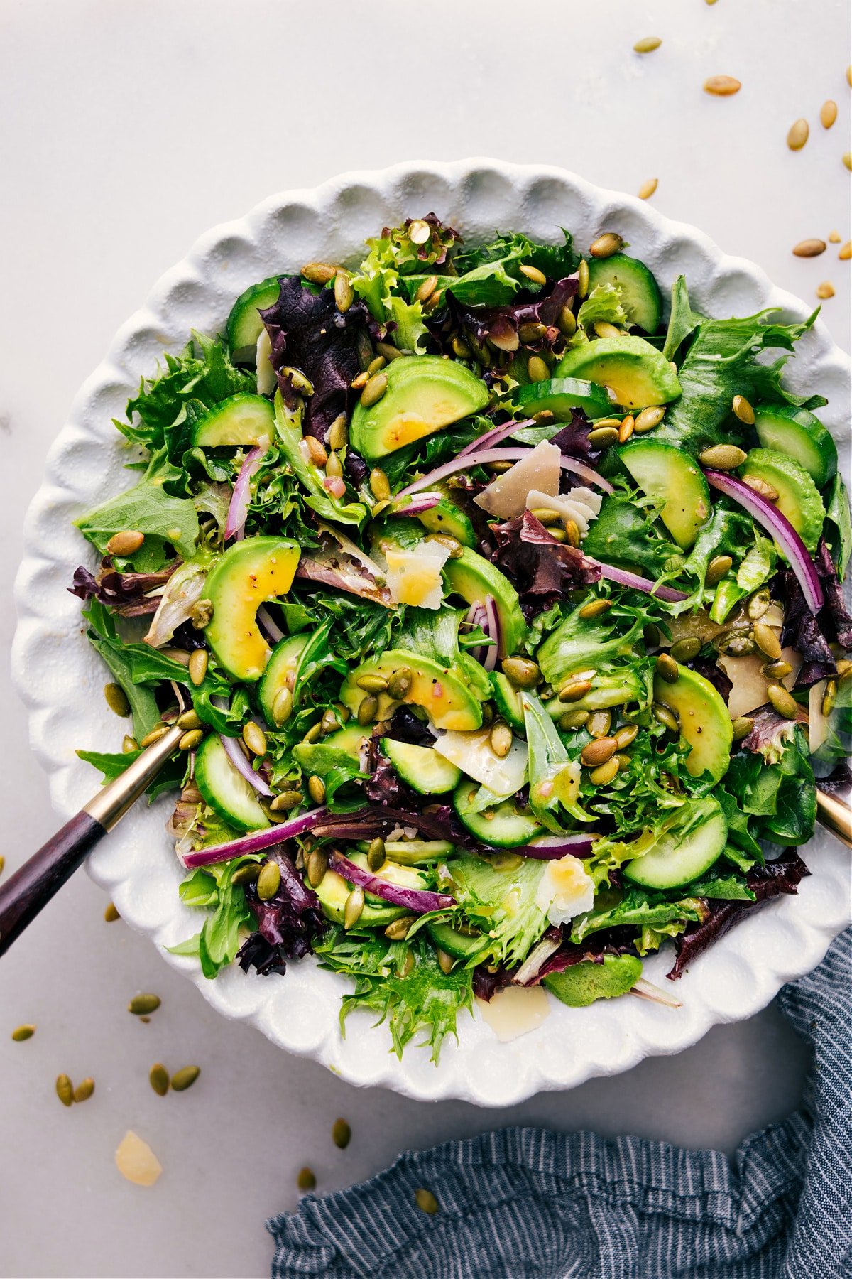 Favorite Everyday Salad Recipe in a bowl with dressing poured over.