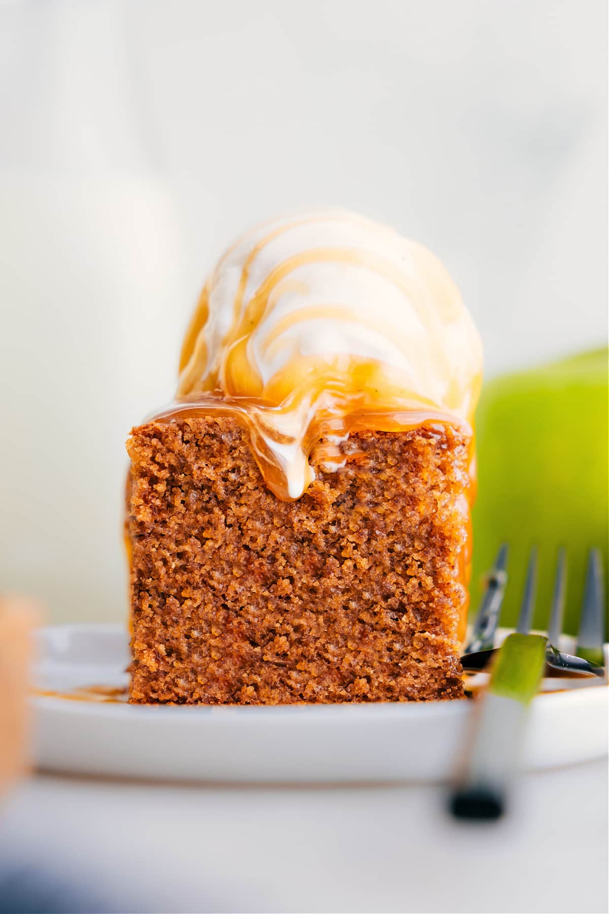 Serve Healthy Apple Cake on a plate topped with ice cream.