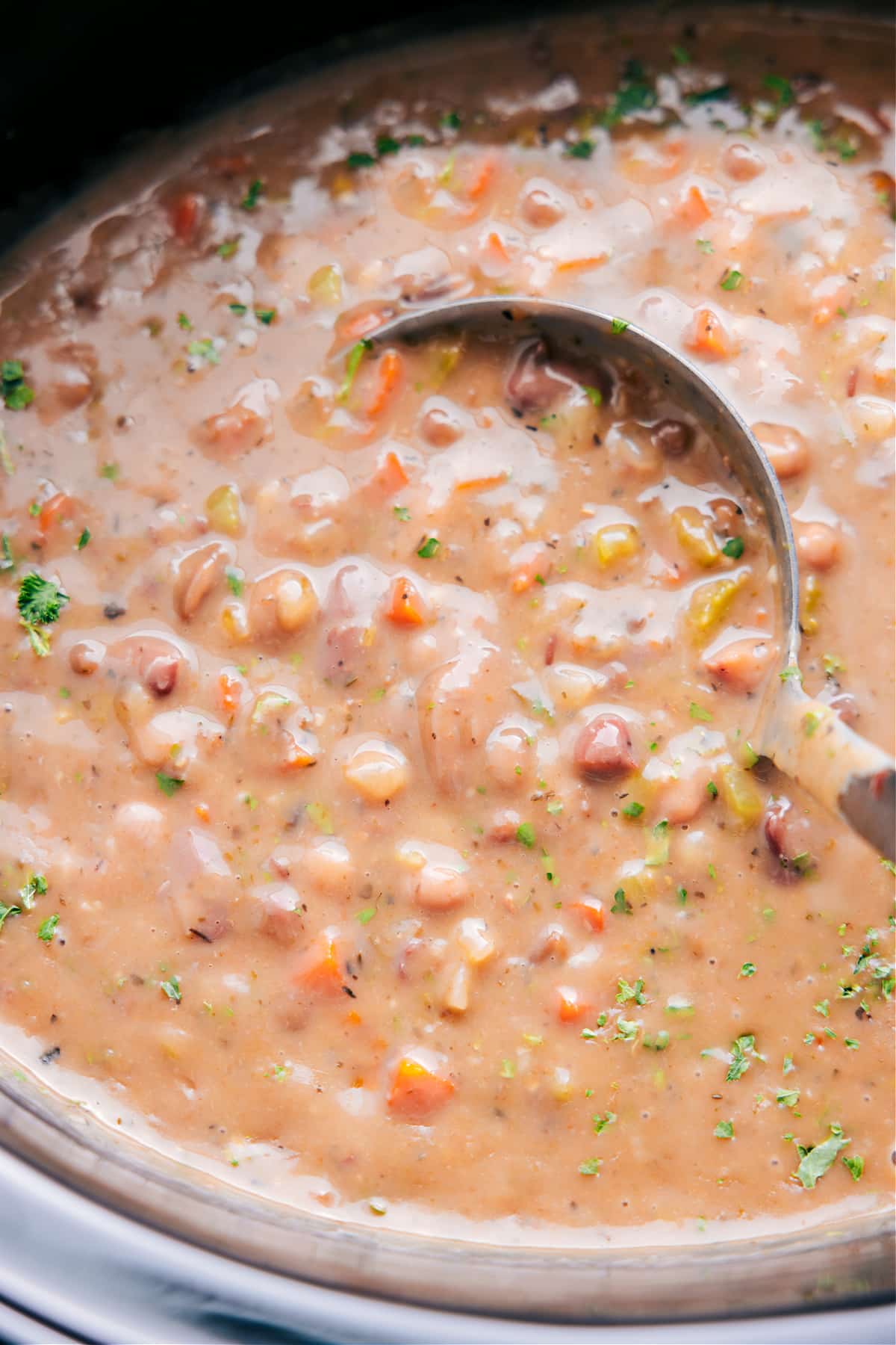 Scooping up 15-Bean Soup with a ladle, ready to enjoy.