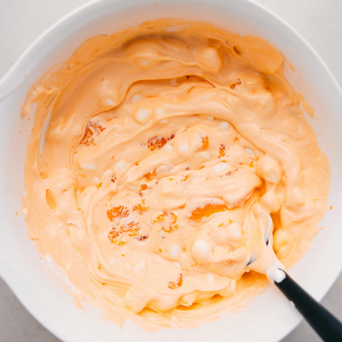 Orange fluff salad in a bowl ready to be served as a delicious side or dessert.