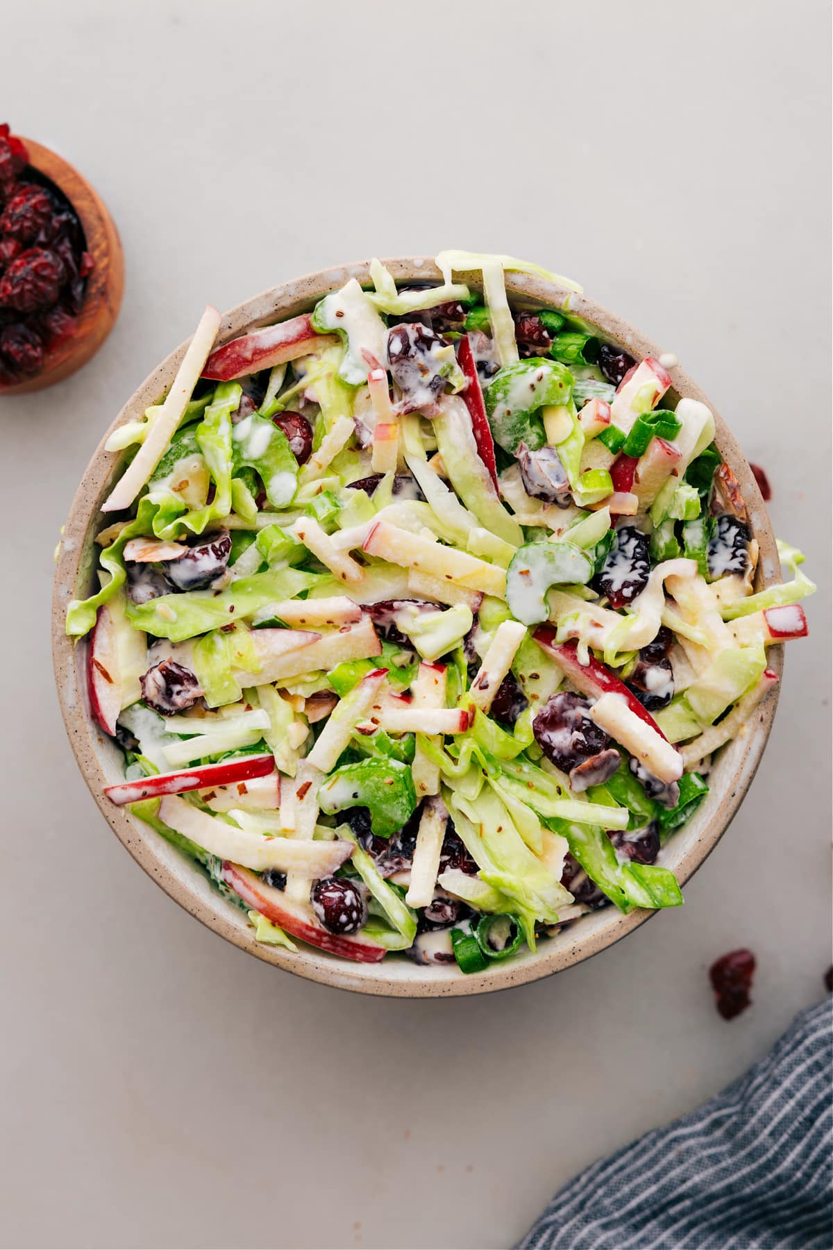 Dressed apple coleslaw in a bowl is ready to serve.