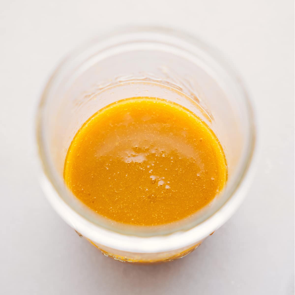 The simple and delicious dressing mixed together in a mason jar.