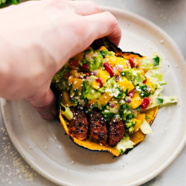 Salmon Tacos on a plate with all the toppings.