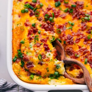 Mouthwatering Twice-Baked Potato Casserole in a casserole dish, ready to be enjoyed by someone.