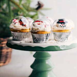 Several gorgeous Christmas cupcakes on a stand, decorated to resemble ornaments, creating a beautiful and festive dessert display.