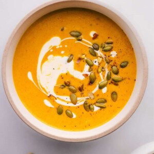 A bowl of pumpkin curry soup ready to be enjoyed.