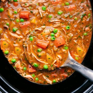 Crockpot Chicken Stew in the crockpot with a big label full coming out.