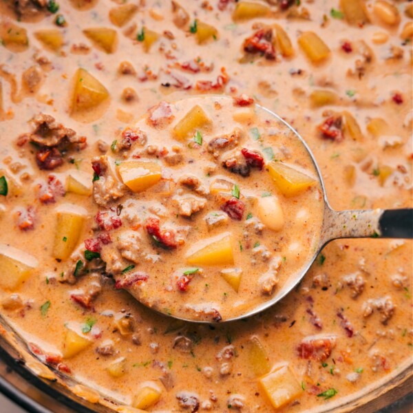 A pan filled with the finished tuscan sausage & potato soup, full of flavor and ingredients, warm and ready to be enjoyed as a delicious meal.