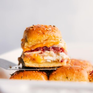 Stack of Chicken Bacon Ranch Sliders, with one sitting on a spatula.