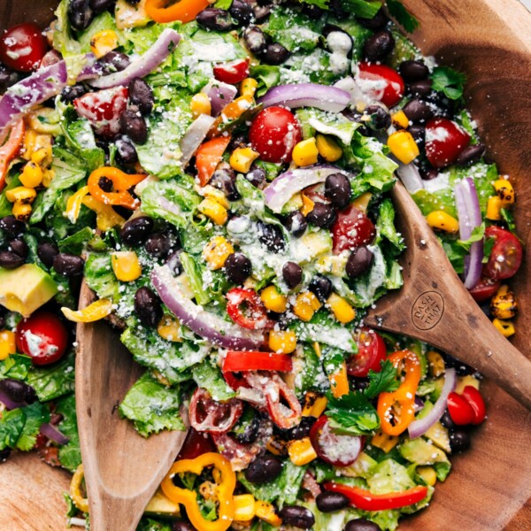 Bowl of Mexican Salad with serving utensils.