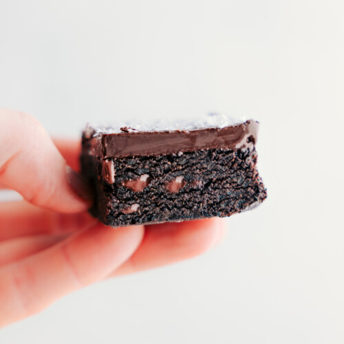 One of the date brownies being held up showing the delicious insides.