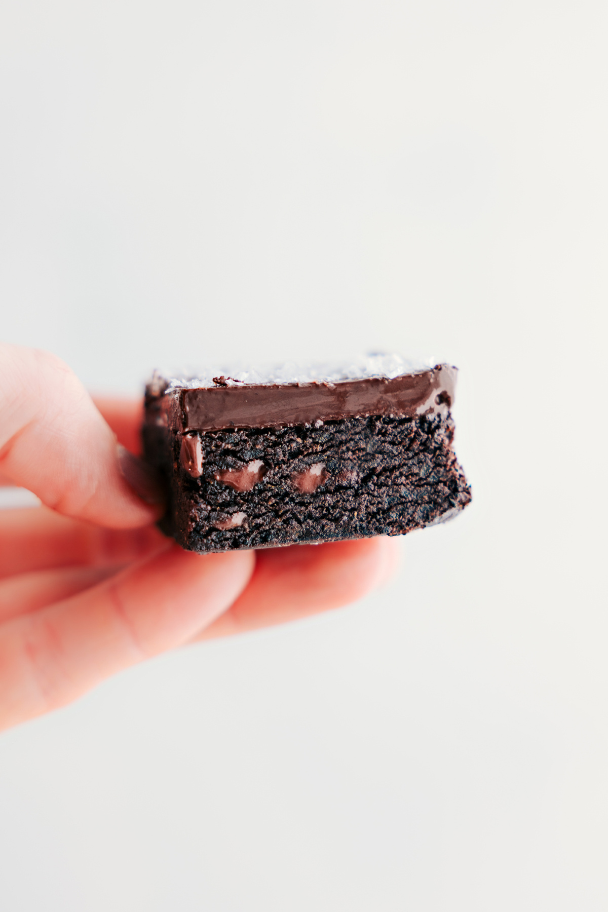 One of the date brownies being held up showing the delicious insides.