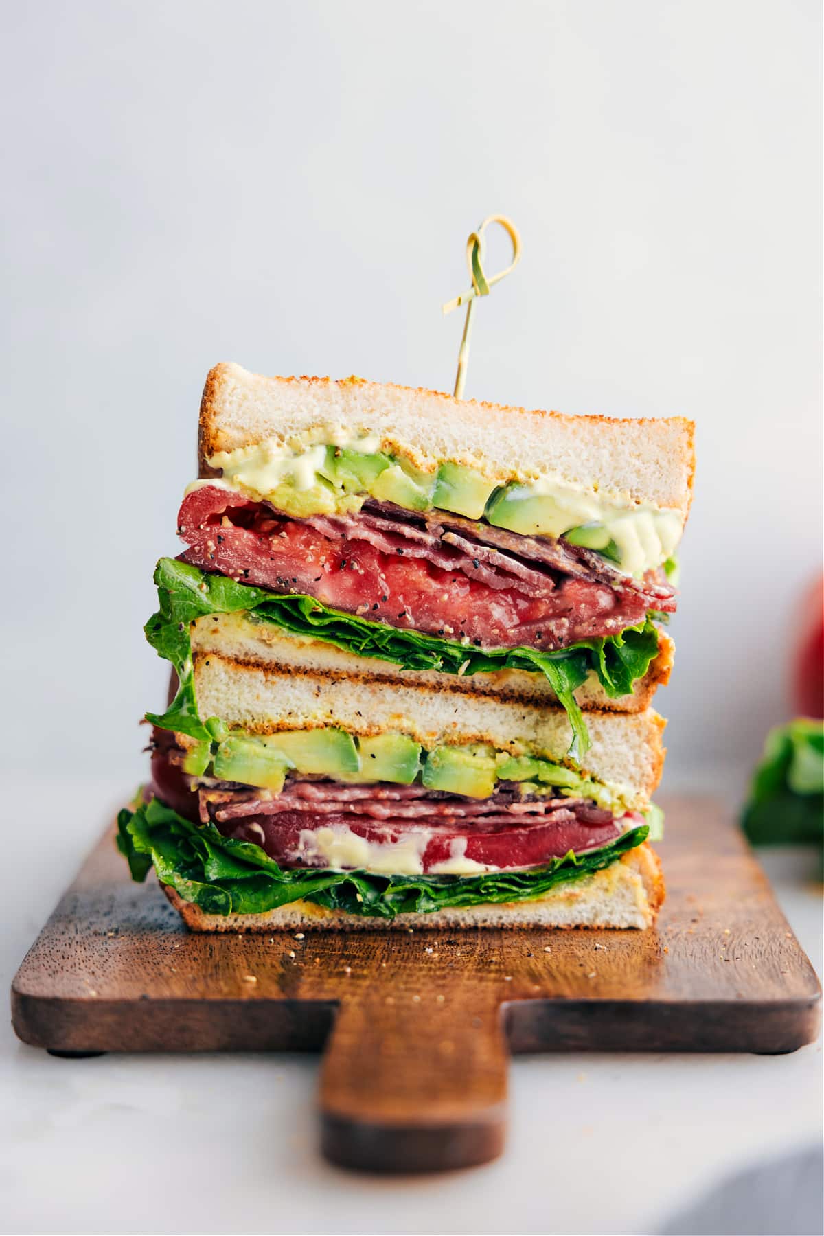 BLT Sandwich cut in half and stacked on top of each other.