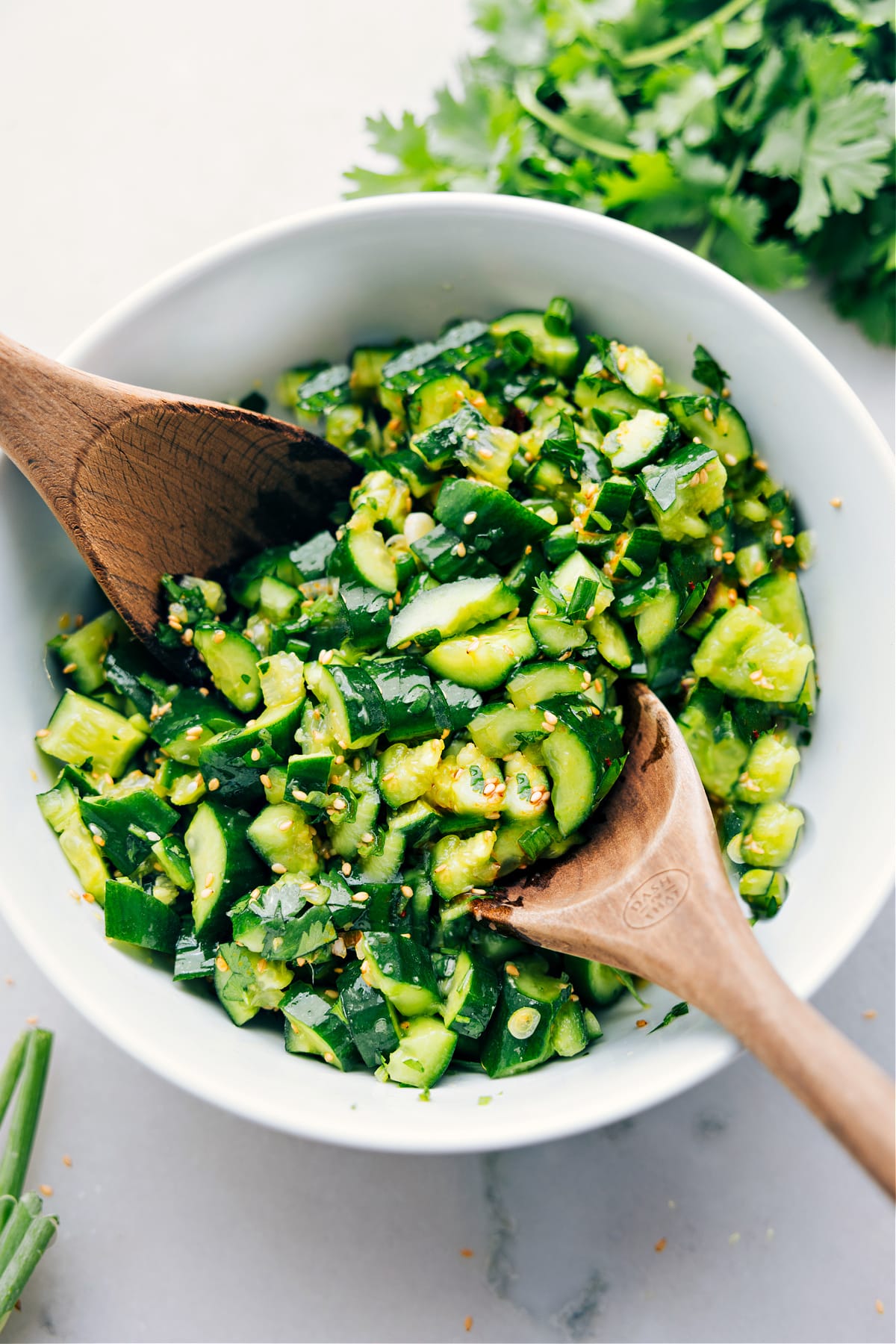 Smashed cucumber salad in a bowl dressed and ready to be enjoyed.