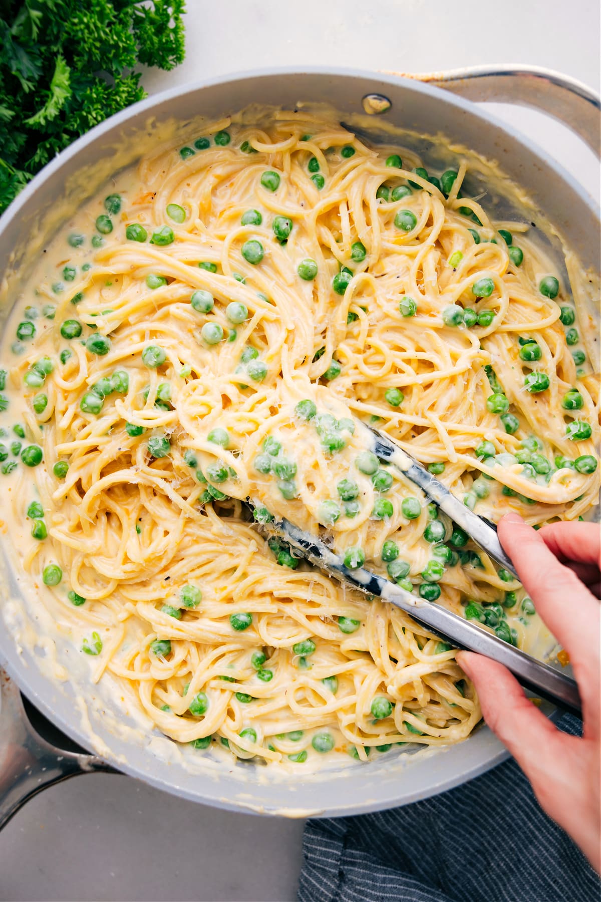 Cheesy Spaghetti in a pot with a scoop ready to enjoy.