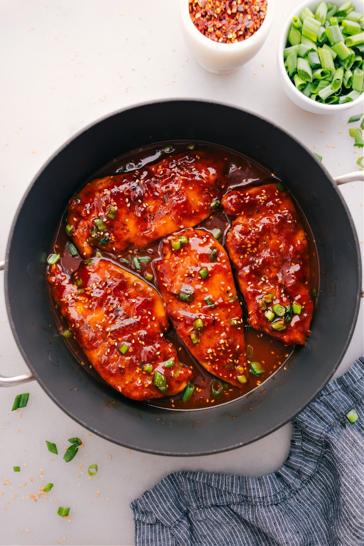 Honey Garlic Chicken cooks in a skillet and gets a topping of green onions.