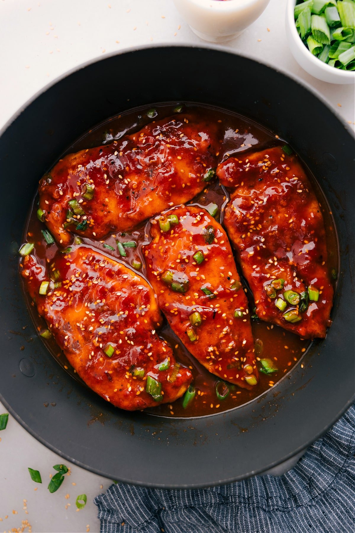 Honey Garlic Chicken, topped with sesame seeds and green onions, is ready to serve and enjoy.