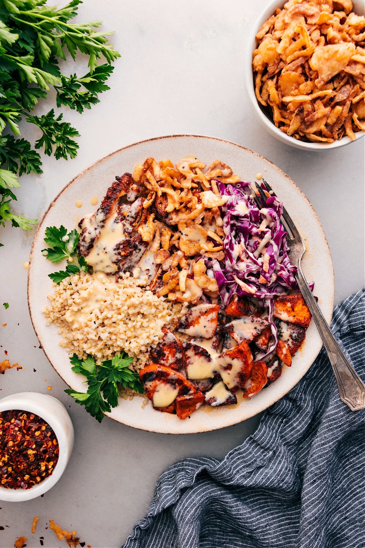 Hot Honey Chicken Bowl topped with dressing, ready to enjoy!