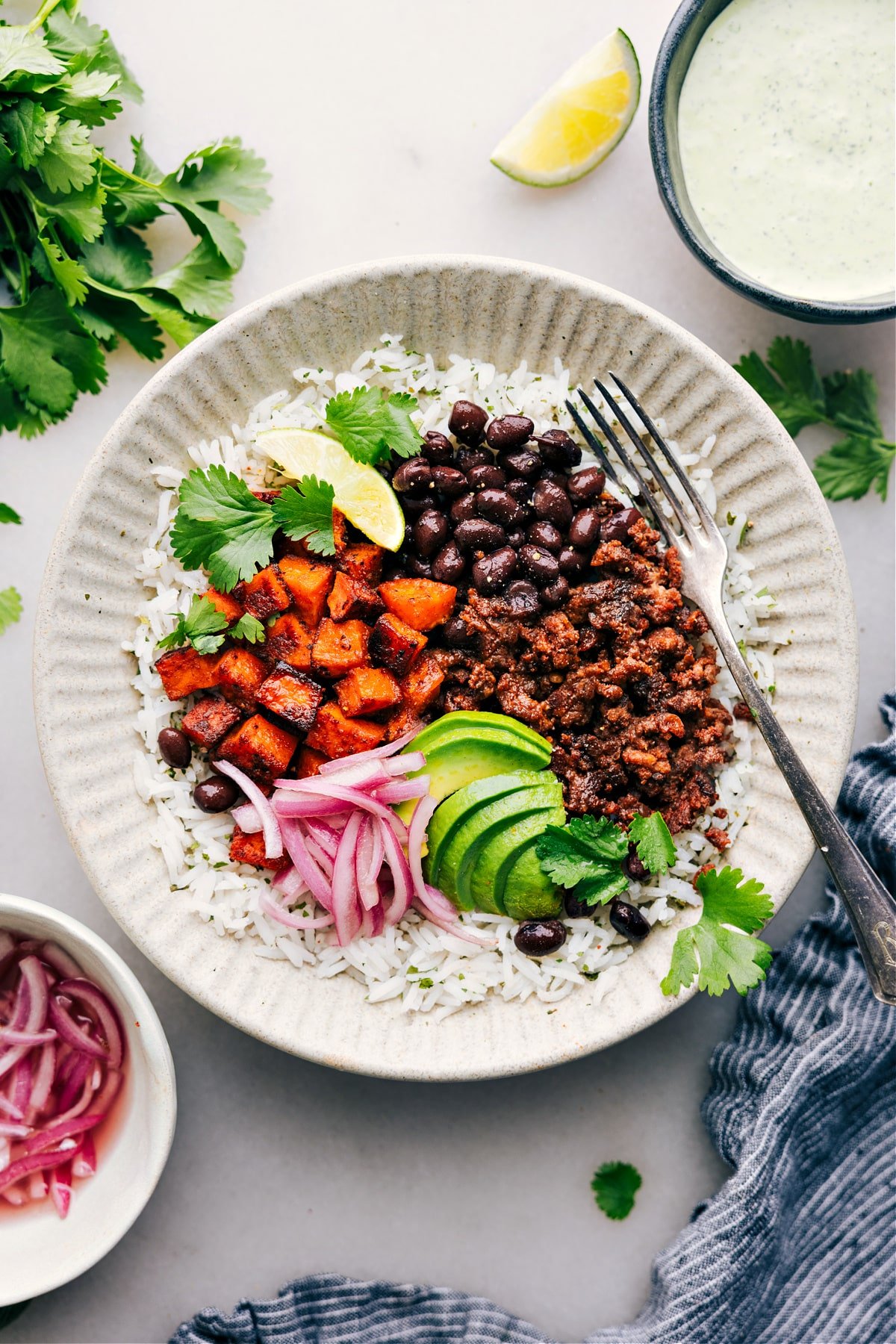 Beef Burrito Bowl with rice, avocado, red onions, and cilantro.