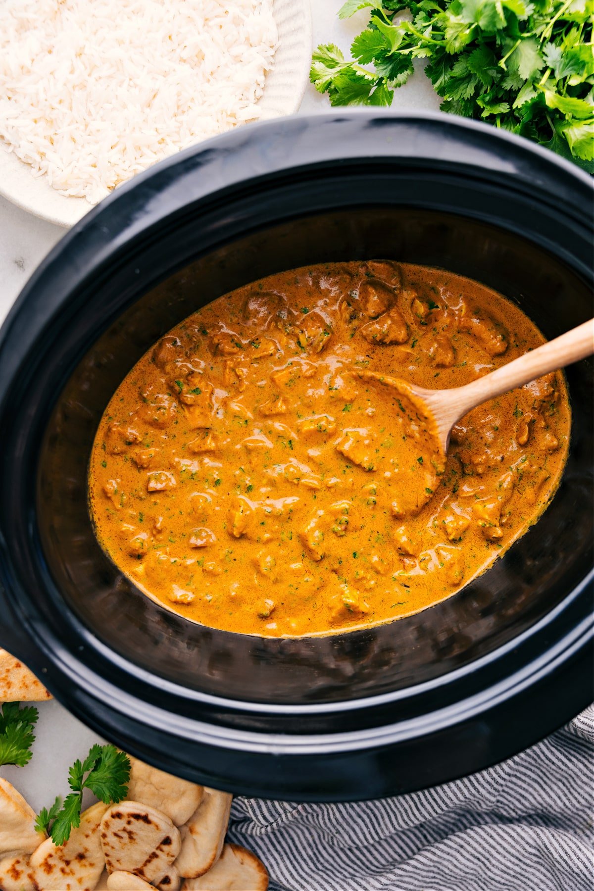 Crockpot Butter Chicken cooks in the slow cooker and is perfect for serving over a bed of rice.