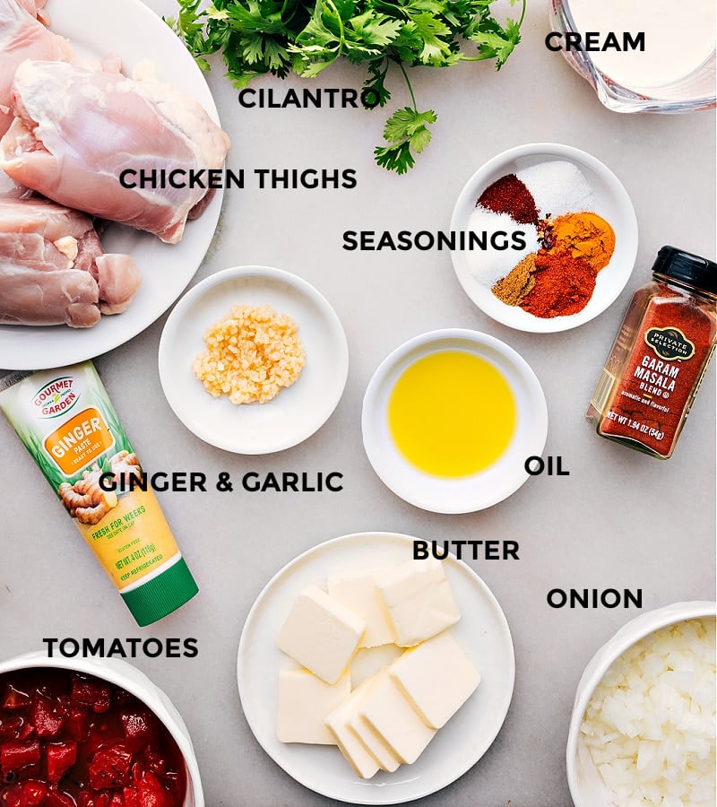 
All the ingredients for this recipe are prepped and ready for easy assembly: chicken, oil, spices, tomatoes, onions, garlic, ginger, and butter.