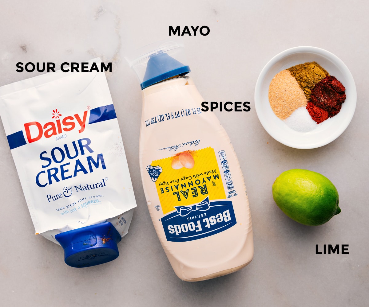 Dressing ingredients prepped for easy assembly in this Southwest Chicken Salad recipe: sour cream, mayo, spices, and lime.