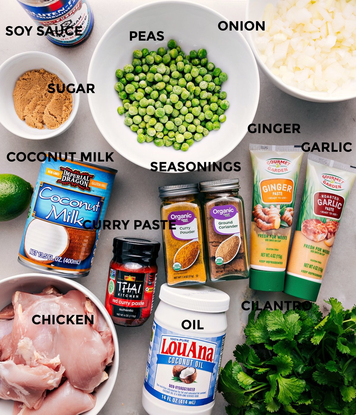 All the ingredients are prepped for easy assembly—peas, onion, garlic, ginger, seasonings, soy sauce, sugar, coconut milk, red curry paste, meat, oil, and cilantro.